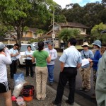 Multi-agency crew assembled for instructions.