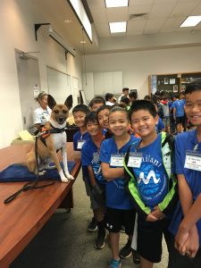 Students pose with the detector dog
