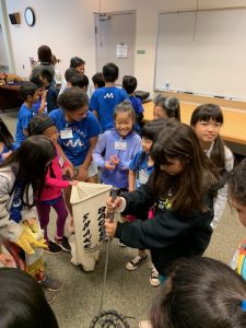 Students learn how to catch a snake...a fake one.